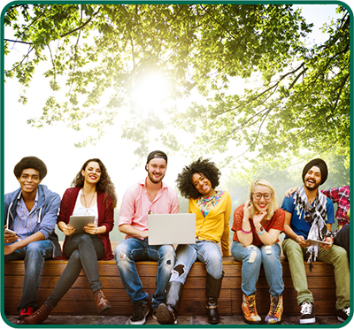 students sitting in front of a tree