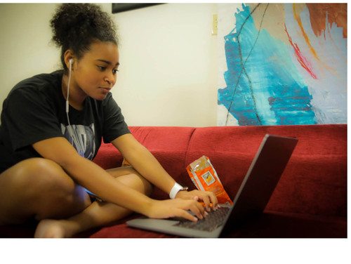 girl sitting in front of a laptop