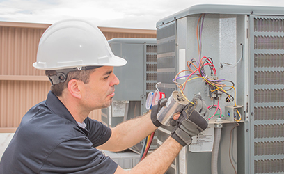 HVAC tech working on an outside unit