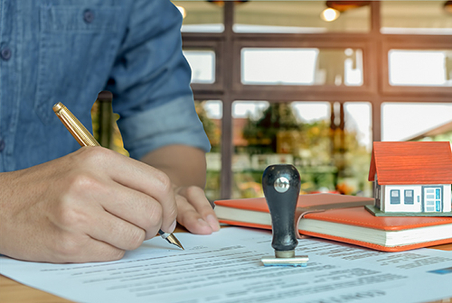 picture of hand signing a document