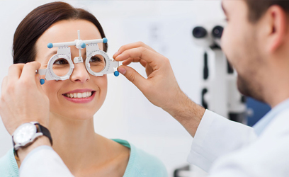 female having her eyes checked by an optician