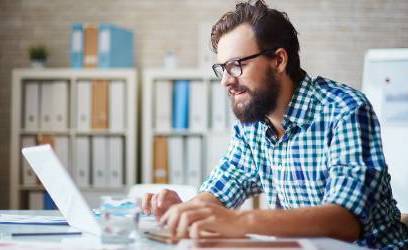 man with beard at a laptop