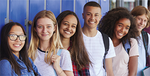 group of teens leanding against a wall