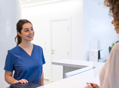 Friendly Medical Receptionist Welcoming Patient
