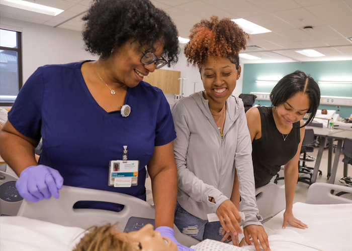 nursing students practicing on a dummy